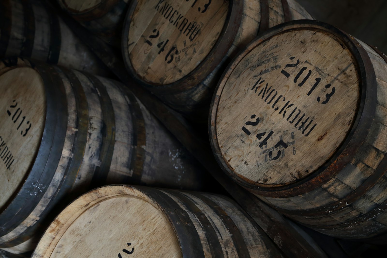 Oak barrels aging Mexican whisky in a warehouse